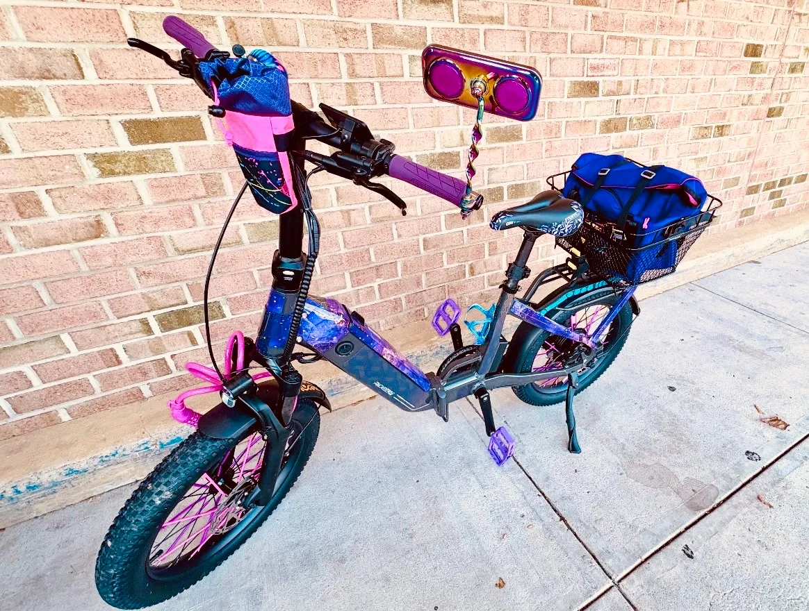 A purple and pink bicycle decorated with custom details